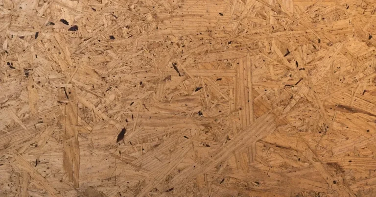 Close-up of an oriented strand board surface showing the layered wood strands used in manufactured wood
