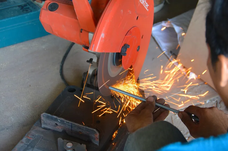Sparks flying off a metal cutting wheel while cutting through steel
