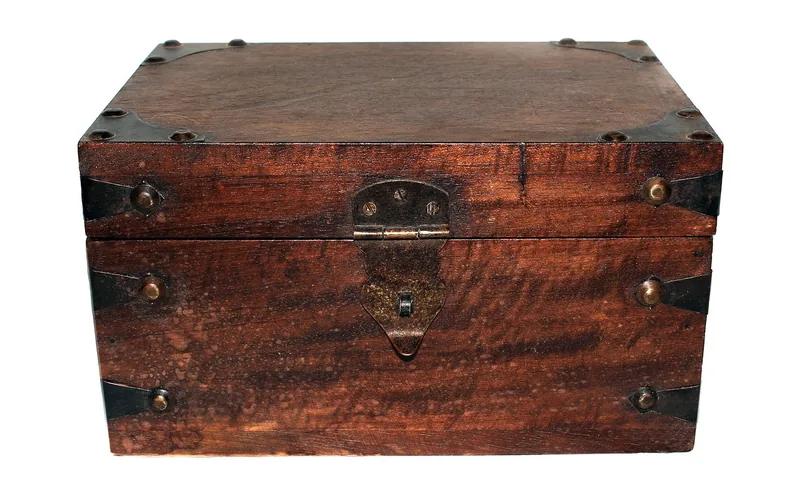 Small old wooden box with metal corner brackets and a brass hasp