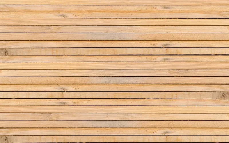Stack of freshly milled pale wood planks before natural darkening from light exposure Stack of freshly milled pale wood planks before natural darkening from light exposure