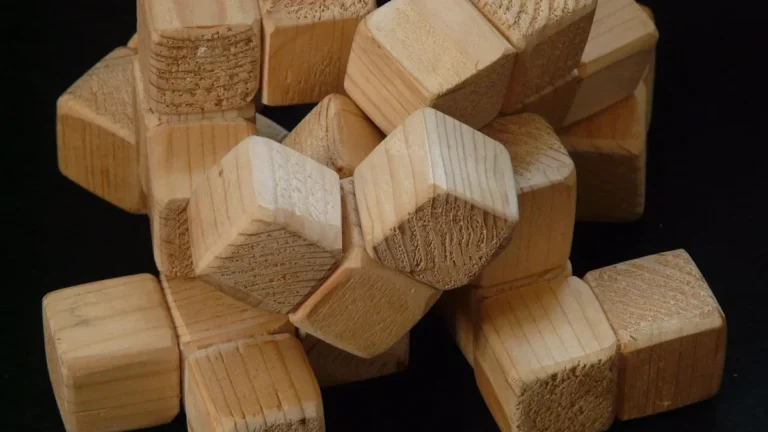 Stack of pale light-colored softwood cubes on a black background