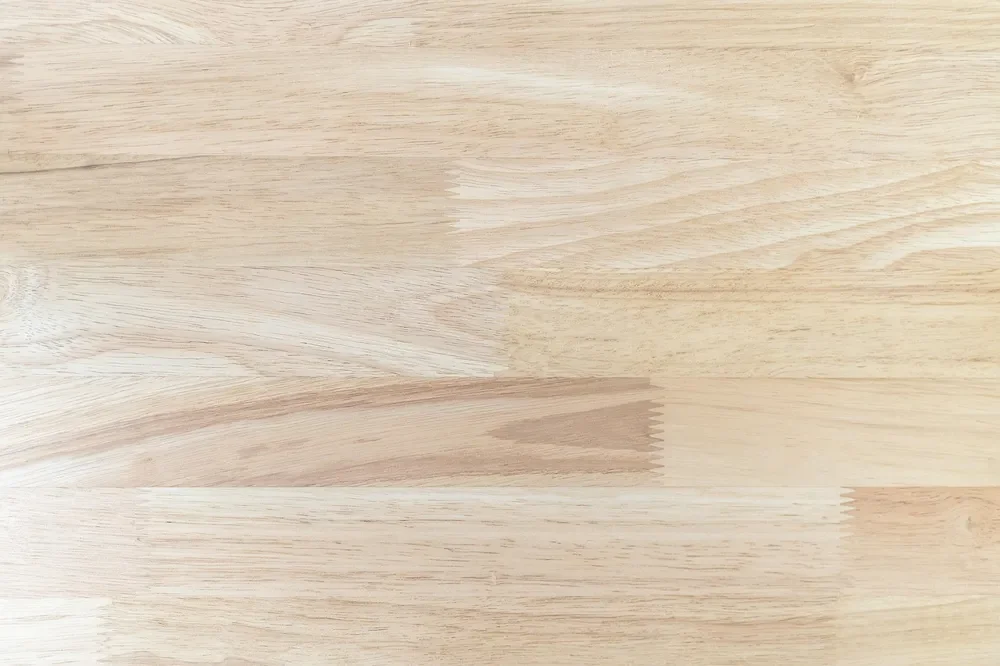 Close-up of pale, even-looking unfinished wood grain before staining