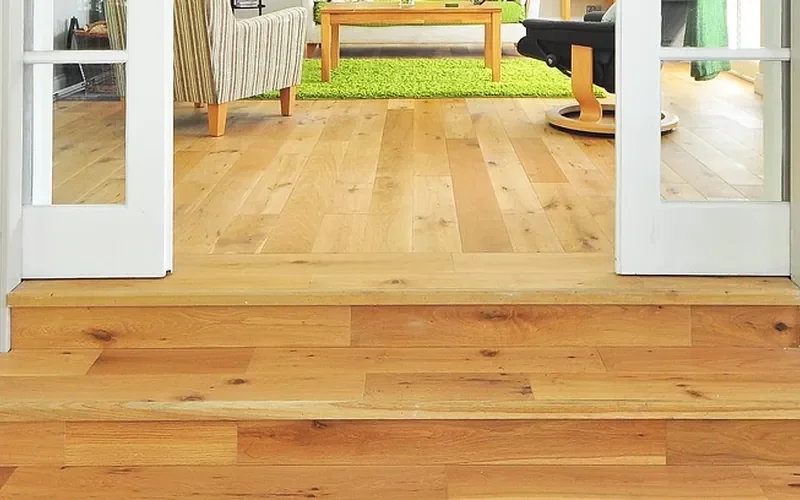 Plank floor running through a doorway and onto a step