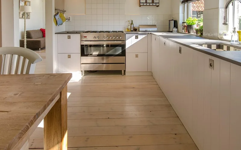 Light plank floor running through a finished kitchen