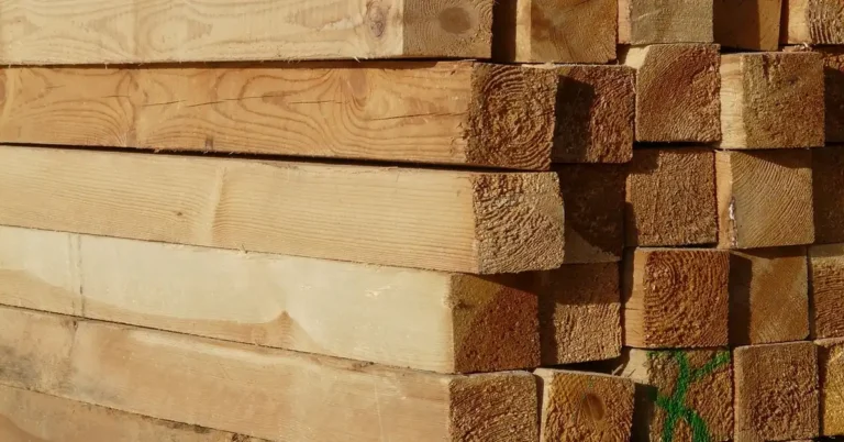 Stack of cut pressure-treated lumber boards showing wood grain and grade marks