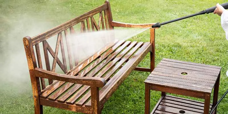 Pressure washing a wood bench too closely can gouge and fuzz softwood