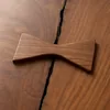 Solid wood bowtie butterfly inlay key for stabilizing a structural crack