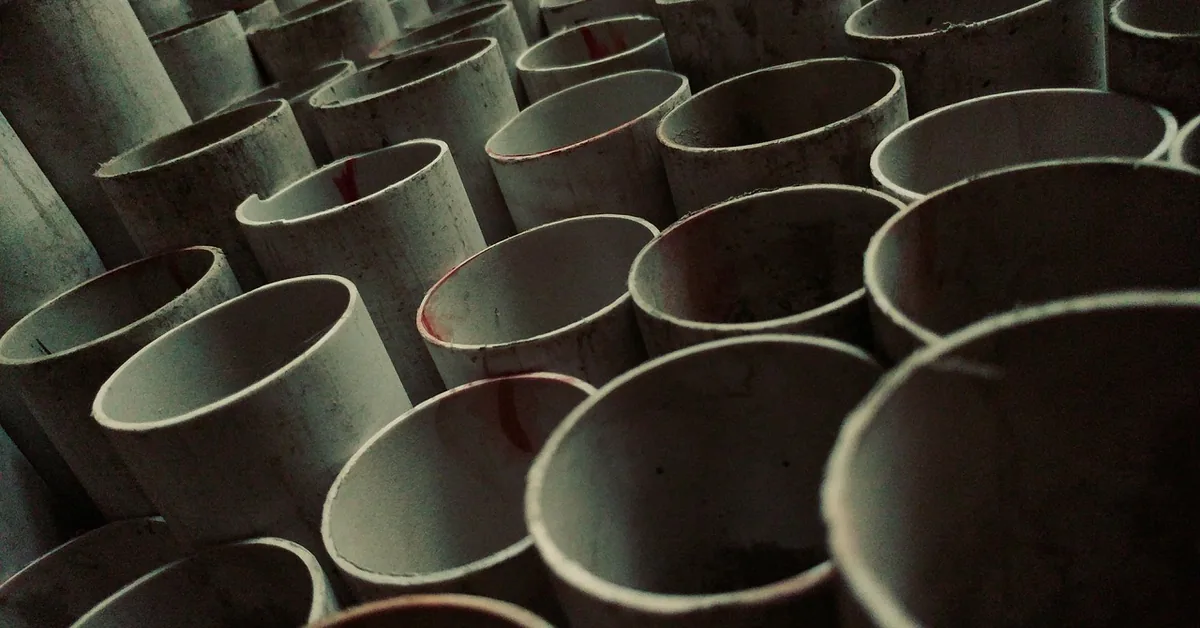 stack of white PVC pipe sections ready for primer and solvent cement bonding