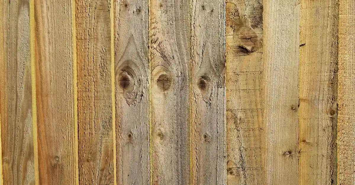 Stack of raw unfinished wood planks showing bare grain with no protective finish