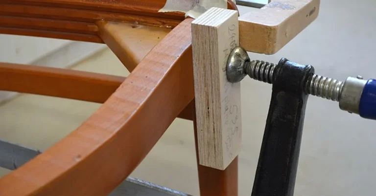 curved rocking chair leg joint being clamped and glued in a woodworking shop