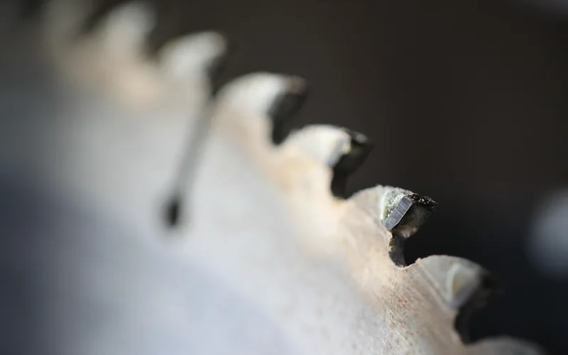 close-up of saw blade teeth bent outward with set, unlike a flush-cut blade close-up of saw blade teeth bent outward with set, unlike a flush-cut blade