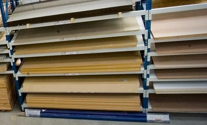Sheet goods stored flat on warehouse racks at a panel supplier