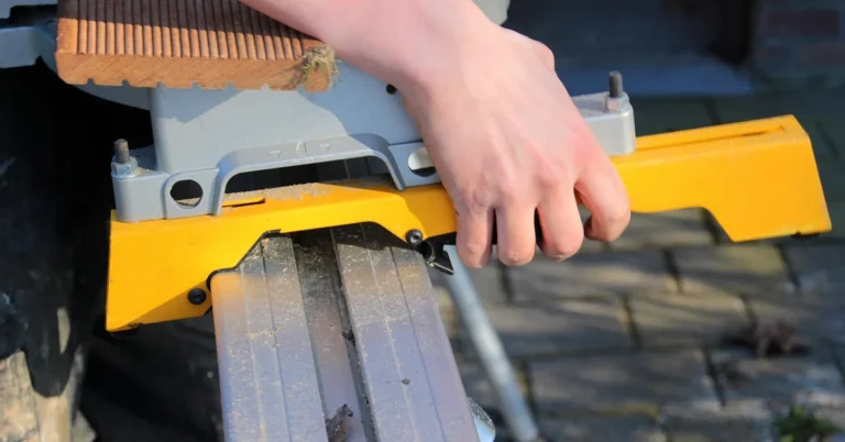 sliding rail mechanism on a 12-inch compound miter saw extended for a wide crosscut