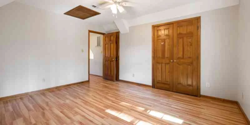 Solid wood panel interior doors in a bedroom with hardwood floor