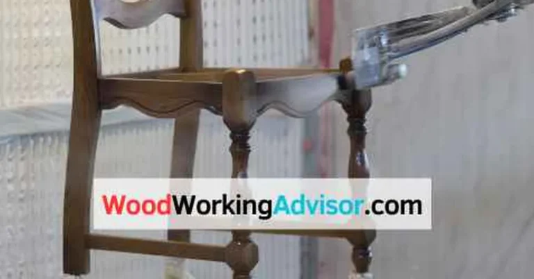 Wood chair mid-spray-paint with primer coat, an example of spray painted outdoor furniture prep