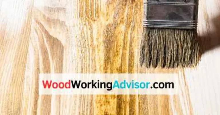 Brush applying stain to pressure-treated wood showing even color penetration