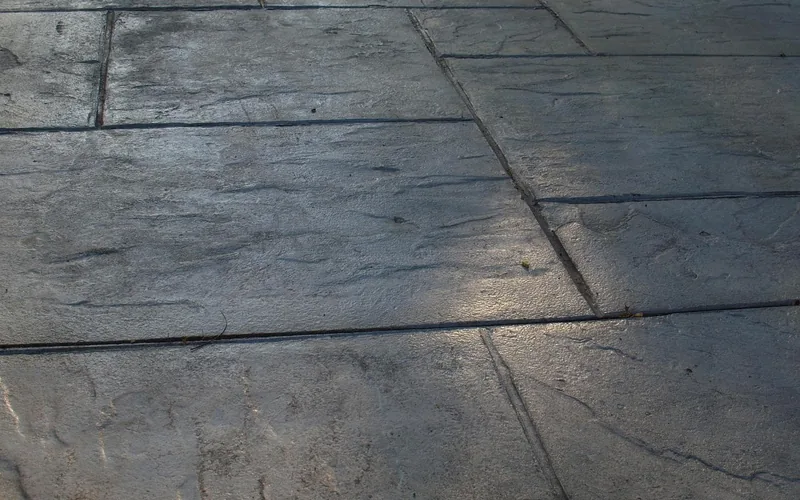 Close-up of a stamped concrete patio surface with scored joint lines