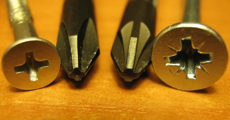 Close-up of a Phillips and a Pozidriv screw head beside two screwdriver tips, the recess shape that strips when a bit slips