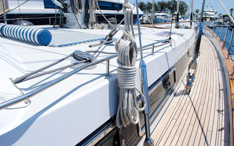 teak side deck planking with dock lines coiled on a sailing yacht
