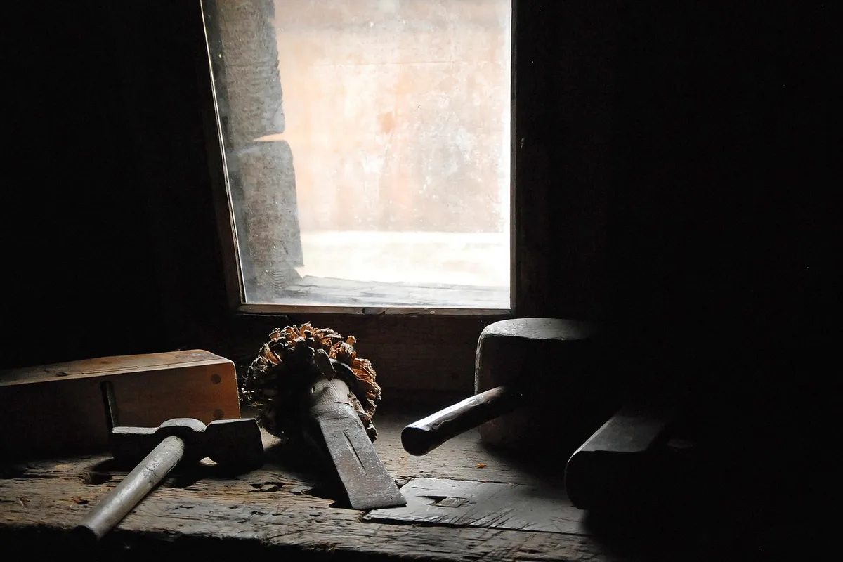Hand tools on a woodworking workshop bench near a window Hand tools on a woodworking workshop bench near a window