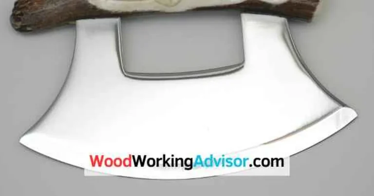Ulu knife with curved stainless steel blade and antler handle on wood surface
