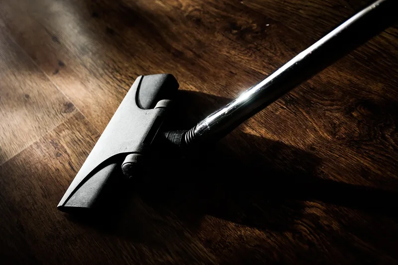 Vacuum cleaner head gliding across a hardwood floor Vacuum cleaner head gliding across a hardwood floor