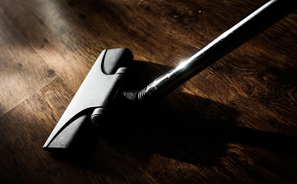Vacuum nozzle cleaning a hardwood floor Vacuum nozzle cleaning a hardwood floor