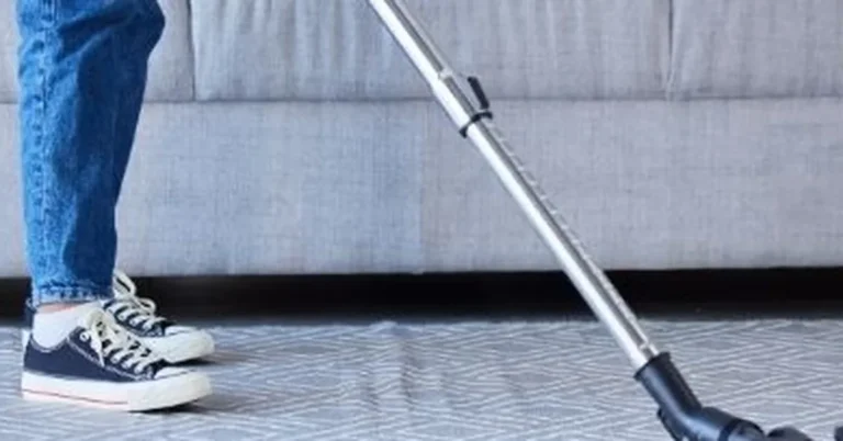 Vacuuming an area rug on a hardwood floor without water or harsh cleaners
