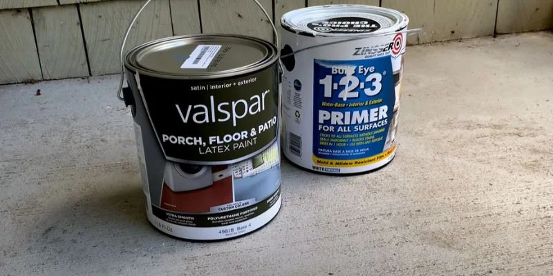 A can of Valspar paint next to a can of Zinsser Bulls Eye 1-2-3 primer used to prep bare wood before painting