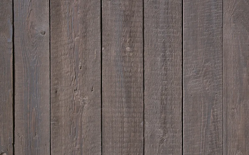close-up of vertical wood plank wall paneling showing grain and seams close-up of vertical wood plank wall paneling showing grain and seams