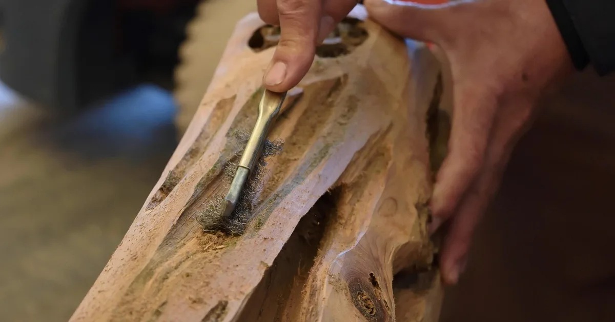 Hand-carving a wood blank with a gouge, part of shaping a wand wood by hand