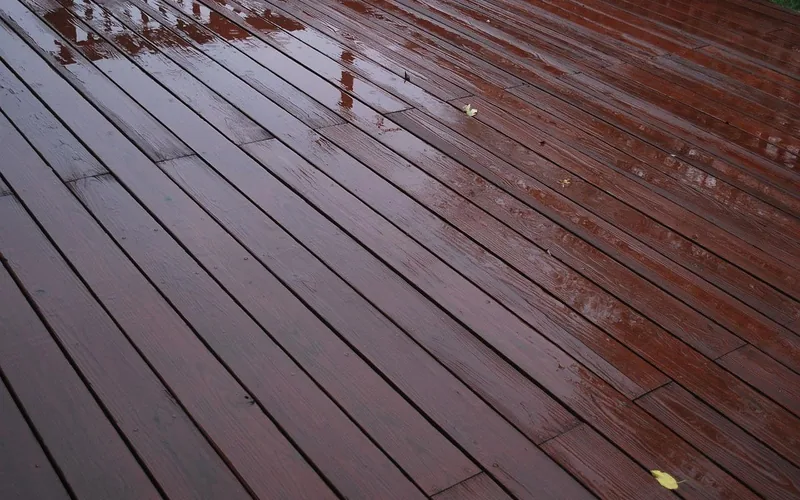 Wooden deck boards slick and wet after rainfall