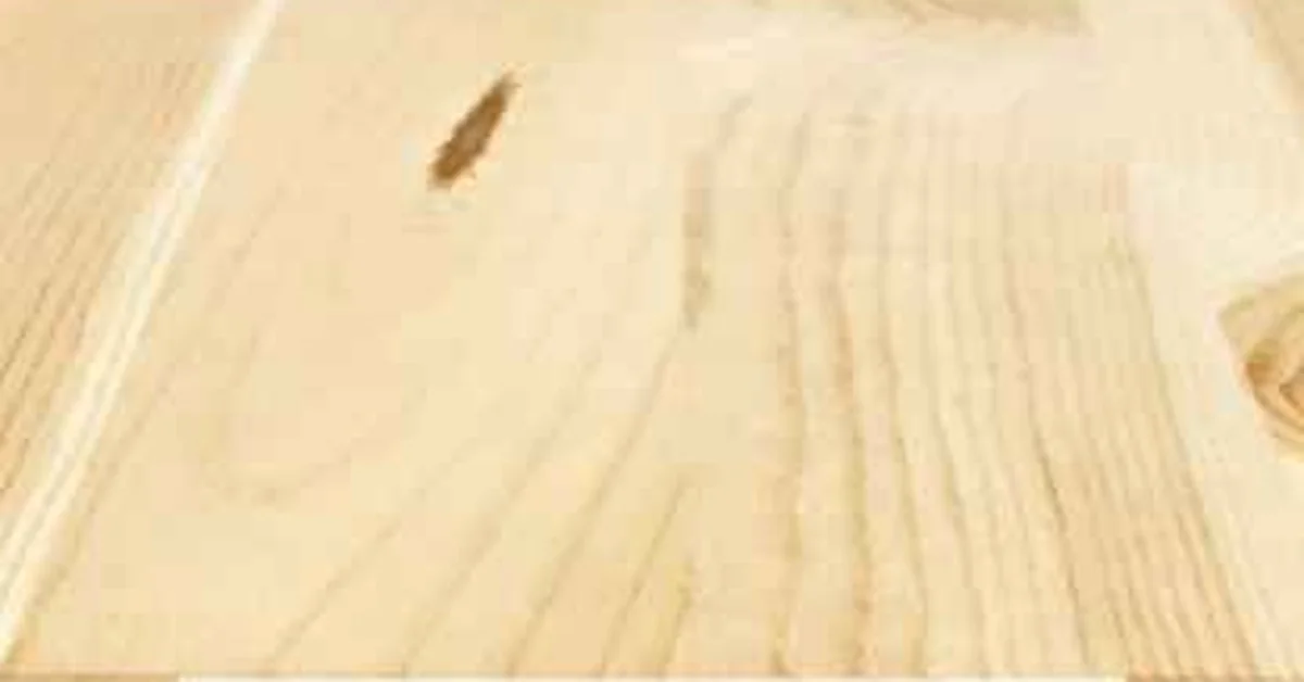 Close-up of a solid wood countertop slab showing natural grain and a knot