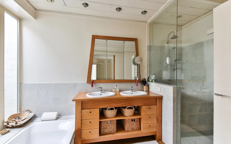 wood bathroom vanity cabinet in a humid room
