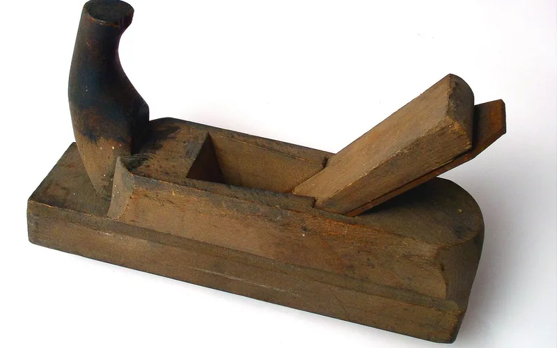 traditional wood hand plane tool used for smoothing board surfaces