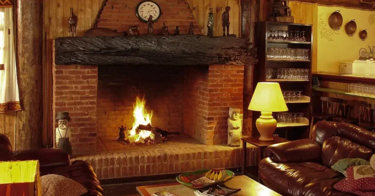 brick fireplace burning firewood in a wood-paneled living room