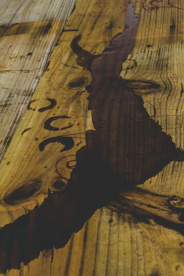 Wood table surface showing dark water ring stains from unprotected drinks Wood table surface showing dark water ring stains from unprotected drinks