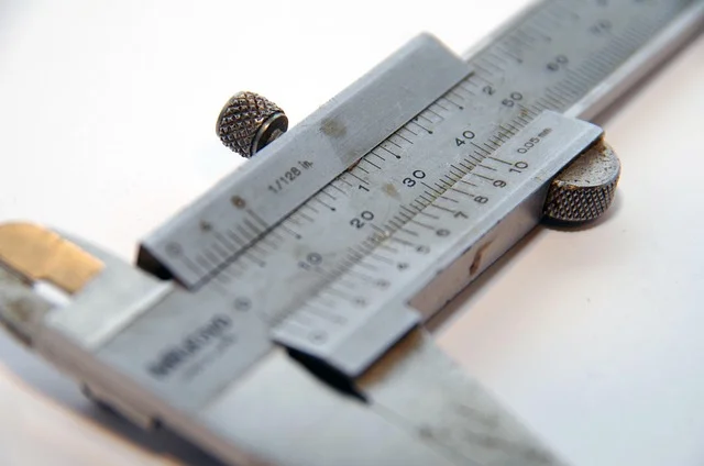Close-up of a vernier caliper reading a precise thickness measurement