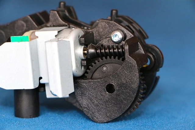 Close-up of a worm gear meshing with a toothed gear wheel, the same mechanical principle used in a table saw elevation and bevel mechanism