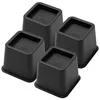 Set of four black 3-inch plastic furniture risers for desk legs