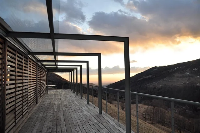 Modern wooden deck with sunset and mountains