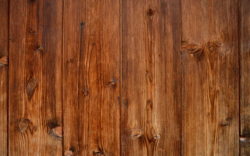 close-up of naturally weathered gray wood grain showing UV photodegradation