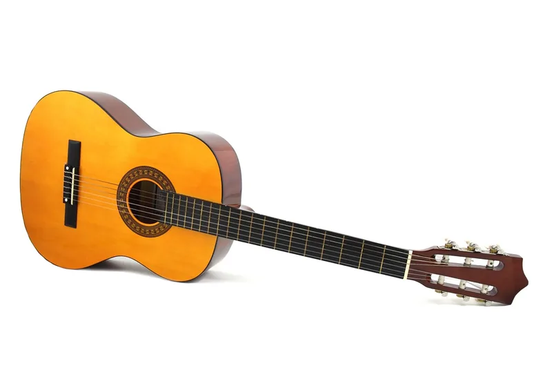 Acoustic guitar with a glossy finished wood body on white
