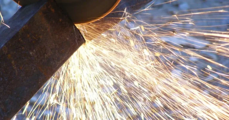 angle grinder cutting metal with a cut-off wheel throwing sparks