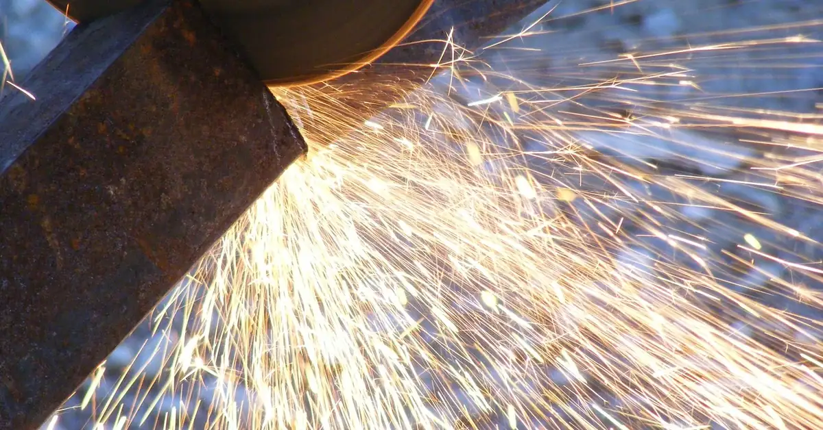 angle grinder cutting metal with a cut-off wheel throwing sparks