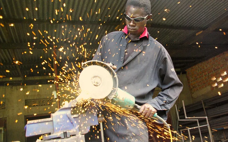 worker wearing safety goggles while cutting steel with an angle grinder worker wearing safety goggles while cutting steel with an angle grinder