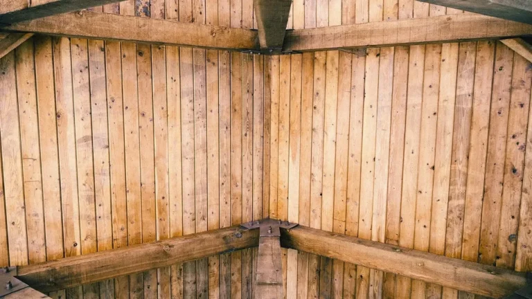Exposed wooden ceiling beams and timber framing seen from below