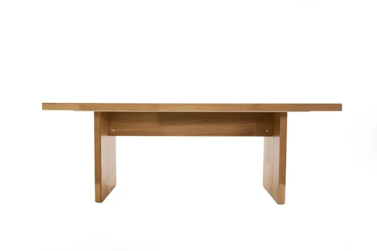 Simple solid wood dining table with slab legs and visible straight grain