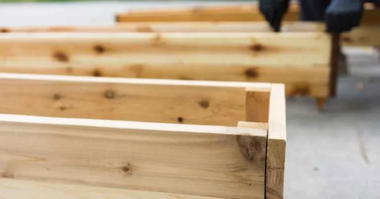 row of finished cedar planter boxes lined up outdoors, natural wood grain visible
