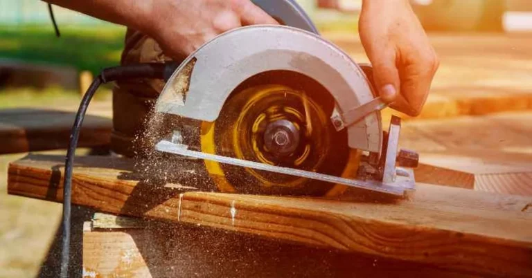 Circular saw blade and base plate cutting through a wood board